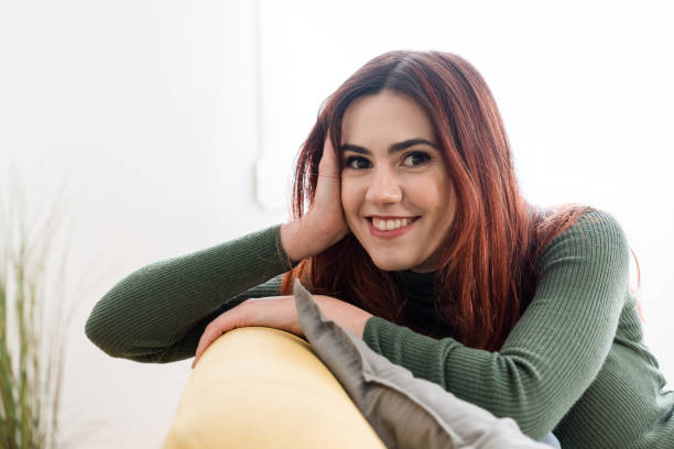 istock Smiling woman in sweater looking at camera 1475276916