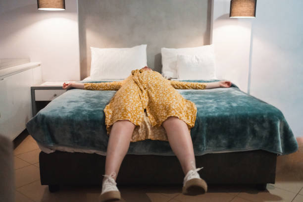 istock An unrecognizable tired woman resting on a hotel bed 1475277962