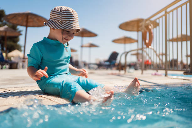 kleinkind genießt einen tag im schwimmbad - ein junge allein stock-fotos und bilder