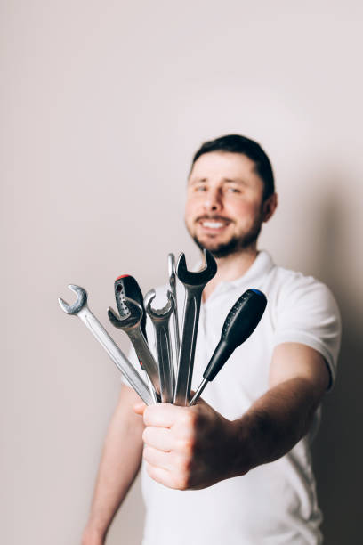 istock Man with bouquet of wrenches and screwdrivers 1475279710