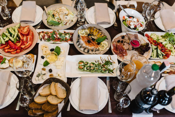 istock Served dinner table in restaurant interior. Wedding festive dinner. Delicious dishes on the table in the restaurant. Serving table, birthday setting. Top view. 1475280667