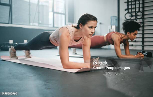 Woman Fitness And Full Body In Plank For Core Workout Exercise Or Training Together At The Gym Women Doing Intense Ab Exercises Balancing On Mat For Strong Healthy Upper Chest At The Gymnasium Stock Photo - Download Image Now