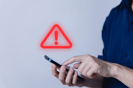 Use a smartphone to show a warning sign icon.