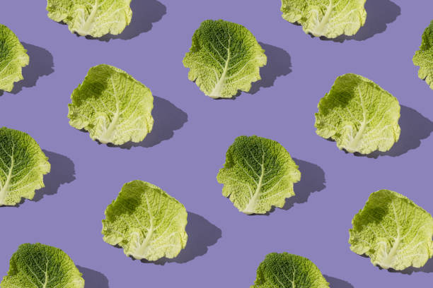 istock Pattern with fresh kale leafs against purple background. Minimal food vegetable concept. 1475286193