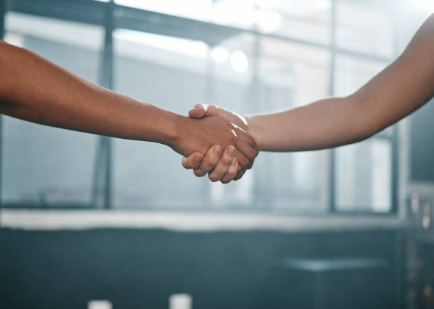 istock Fitness, partnership or people handshake at gym for team work, trust or support after workout or exercise. Community, friends or healthy sports athletes shaking hands after training collaboration 1475286301