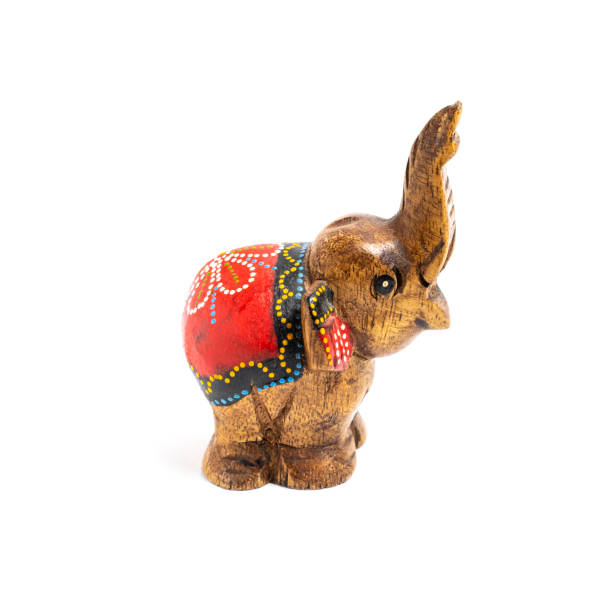 istock Figurine of a wooden elephant with pattern on the back isolated on white background. Decorative figurine of an elephant, hand carved wooden model of an elephant. Statuette, toy, souvenir from Asia 1475287030