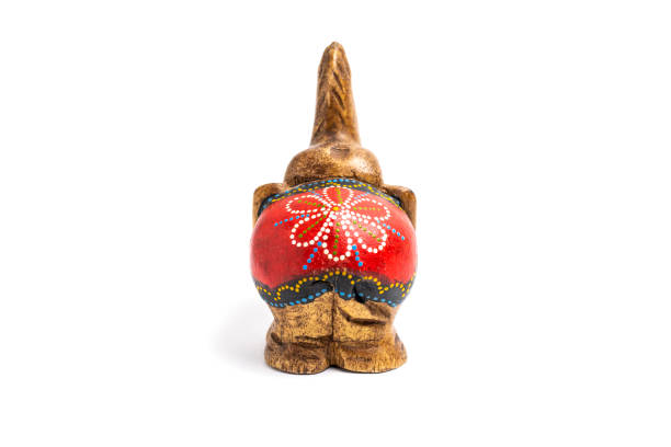 istock Figurine of a wooden elephant with pattern on the back isolated on white background. Decorative figurine of an elephant, hand carved wooden model of an elephant. Statuette, toy, souvenir from Asia 1475287045