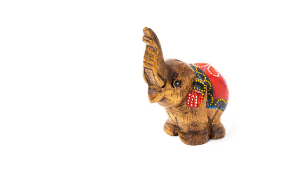 istock Figurine of a wooden elephant with pattern on the back isolated on white background. Decorative figurine of an elephant, hand carved wooden model of an elephant. Statuette, toy, souvenir from Asia 1475287047