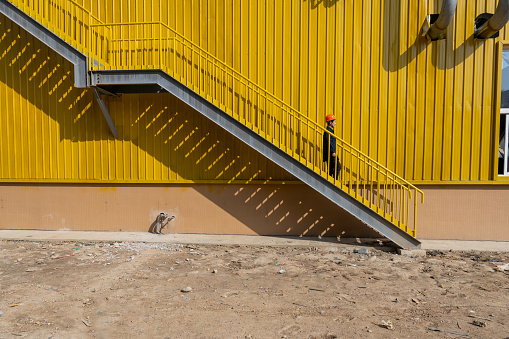 A female engineer climbed the stairs of a chemical plant under construction