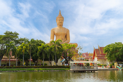 The Giant Golden Buddha in Wat Muang in Sing Buri district near Bangkok. Urban town city, Thailand.