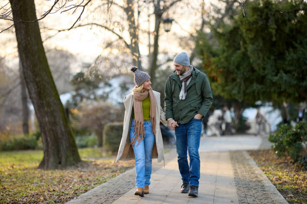 istock Romantic couple enjoying a walk in the park holding hands 1475290362