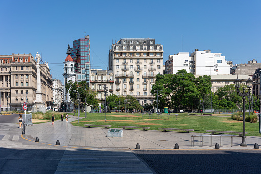 March 22: A busy city plaza in Buenos Aires. Photo contains people and cars.