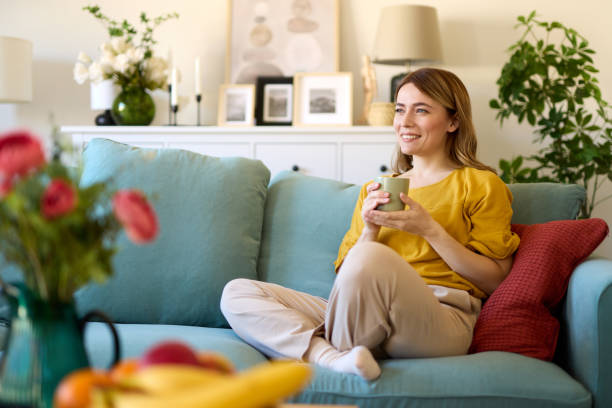 istock An attractive young woman relaxing at home drinking coffee 1475291727