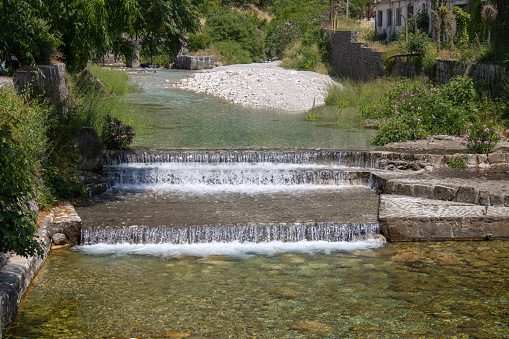 Mountain river cascades. Noisy waterfall. Clear turquoise water. Beautiful landscape.