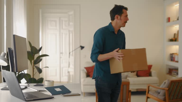 Businessman works at home orders package