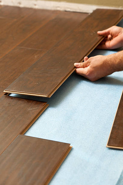 istock Man Installing New Laminate Wood Flooring 147529294