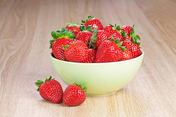 istock strawberries in a plate on the wooden table 147529473