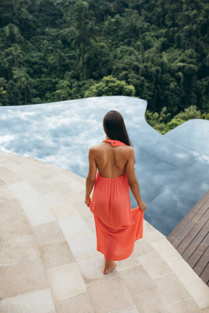 istock Female model in sundress at poolside 1475300915