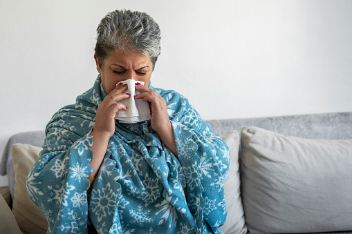 Woman blowing her nose