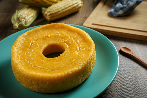 corn cake with a cup of coffee and ears of corn in the background