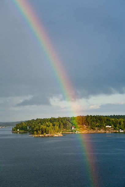 istock rain rainbow  during sunshine in Baltic sea 147530304