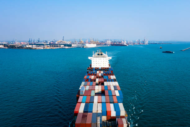 istock Aerial front view container cargo ship carrying commercial container in import export business commerce logistic and transportation of international by container ship 1475304390