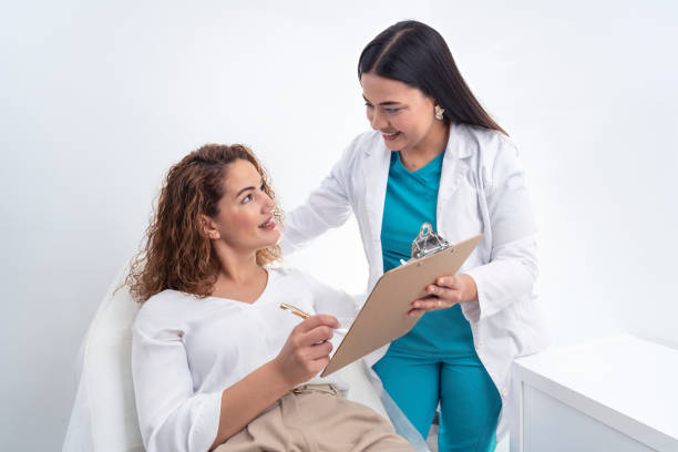 Delighted female doctor explaining information to patient in clinic