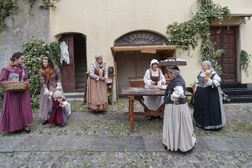 Taggia, Italy - February 26, 2023: Historical reenactment in the old town of Taggia, in Liguria region of Italy. The actors acting out episodes of daily life in settings that evoke moments of life lived fully the seventeenth century. The episodes depicted are inspired by true events, drawn from documents preserved in the Historical Archives