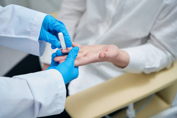 istock Healthworker makes finger puncture for blood sampling with special needle 1475306424