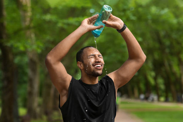istock Tired black guy jogger splashing water on his head 1475307178