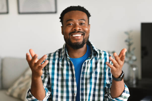 istock Cheerful Black Man Talking Looking At Camera Sitting At Home 1475307190