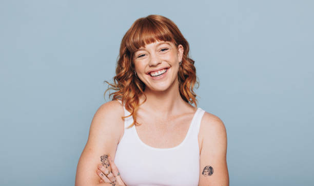 istock Happy red haired woman standing in a studio 1475307657