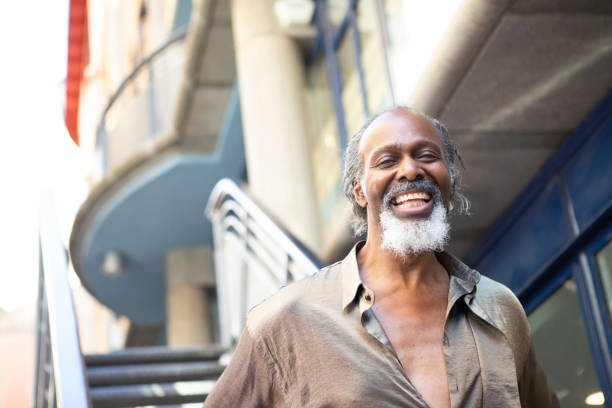 istock Cheerful man standing by exterior stairs 1475308791