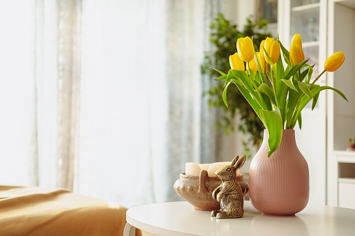 Yellow tulips in a living room.