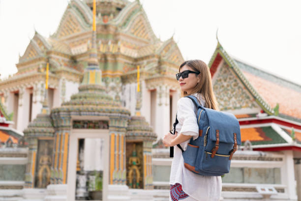 Temples are tourist attractions that calm the mind and feel relaxation. Portrait of Korea woman in causal with blue bag standing in the temple. Holiday vacation trip during weekend activity. Sightseeing at temple and see architecture los templos son atracciones turísticas que calman la mente y sienten relajación. retrato de una mujer coreana en casual con bolsa azul de pie en el templo. viaje de vacaciones durante la actividad de fin de semana. hacer turismo en el templo y ver la arq