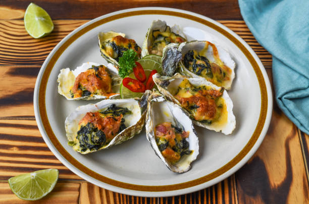 istock Oysters baked with 3 cheeses on white plate close up 1475311946