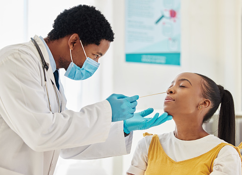 Doctor, black woman or covid swab test in hospital checkup, clinic wellness or bacteria virus control. Patient, cotton or nose with healthcare worker in disease sample, medical research or compliance
