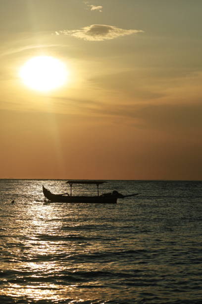 istock sun beams over a boat in the sea 1475314659