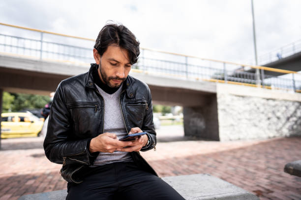 istock Mature man using mobile phone outdoors 1475315641