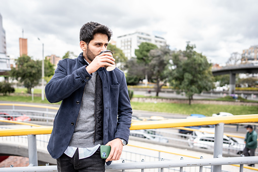 Mid adult man drinking coffee in the city