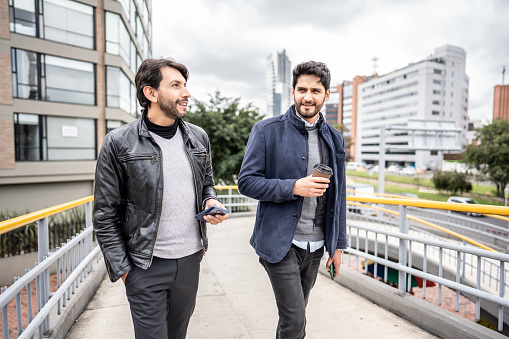 Coworkers talking while walking through the city