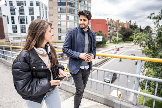 istock Friends talking and walking through the city 1475316132