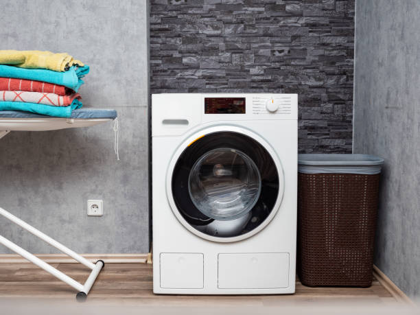 istock Laundry room interior with washing machine against the wall. 1475318863