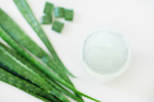 Slice Aloe Vera in glass with pink  creeper and Plumeria flower. Aloe Vera are Digestive help, Treating skin conditions, psoriasis and acne, Sunburn and Heartburn relief and helped lower the blood sugar.