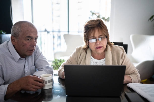 istock Senior couple using laptop doing home finances 1475323603