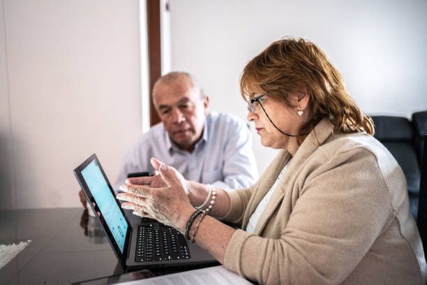 istock Senior couple using laptop doing home finances 1475323604