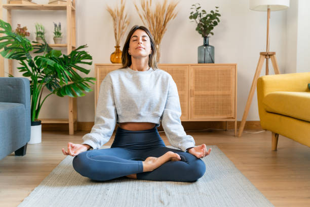 istock Calm woman meditating in lotus pose 1475324714