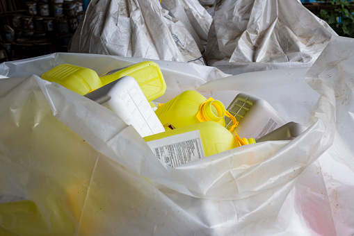 Empty plastic container bottles are used for agricultural farming to store chemicals. The plastics are been collected and stored to be recycled after use.