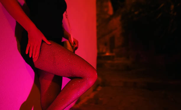 Woman in fishnet stockings waiting at night street stock photo