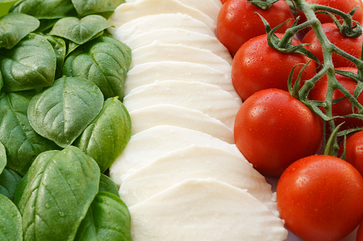 The italian flag (la bandiera italiana) in the three ingredients that form the base of italian cuisine; Basil, Mozzarella, Tomatoes. Verde, bianco e rosso; il Tricolore italiano.